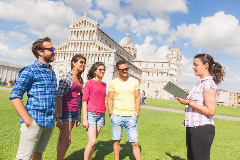 A tour guide giving trivia and facts to tourists.