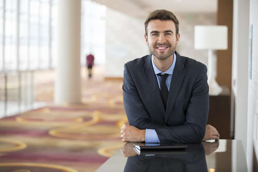 A hotel manager at the lobby supervising.