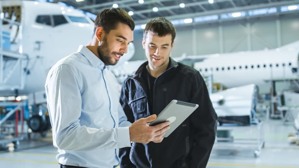 Aircraft maintenance technician having discussion.