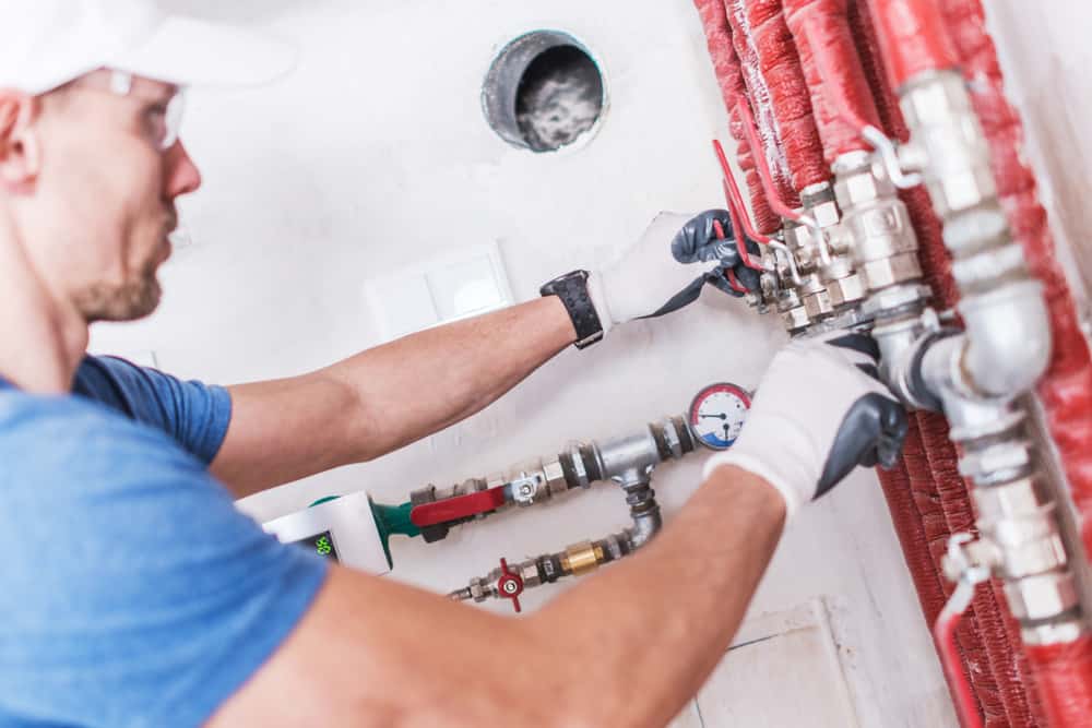 Plumber checking on water valves.