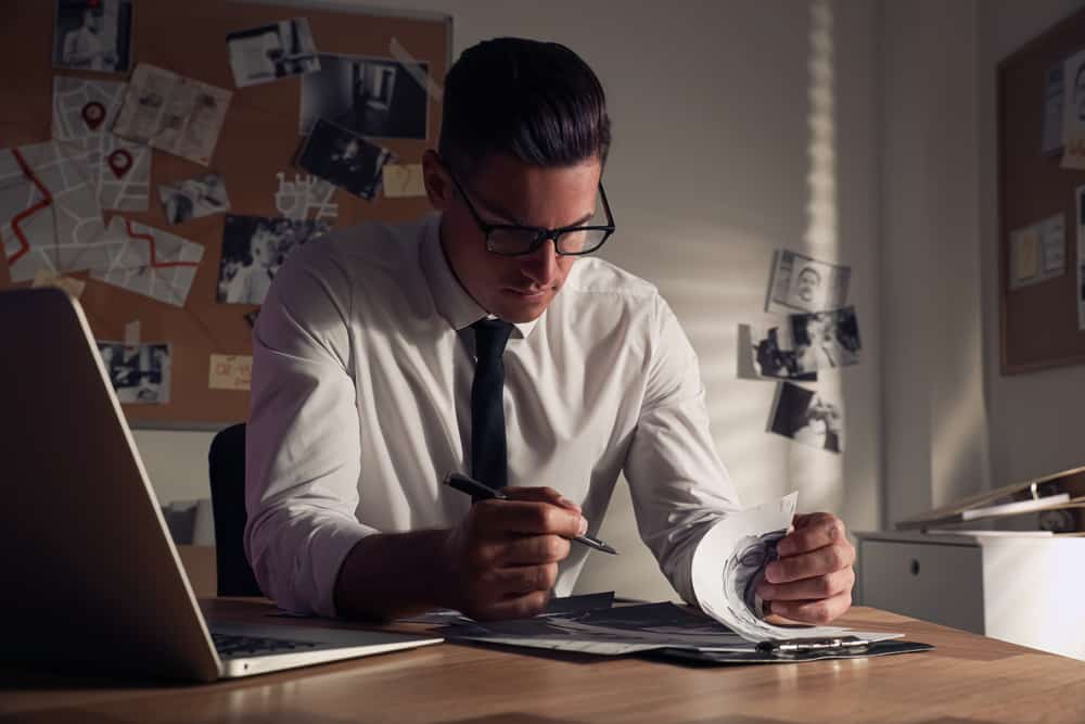 Private investigator working on a case in his office.