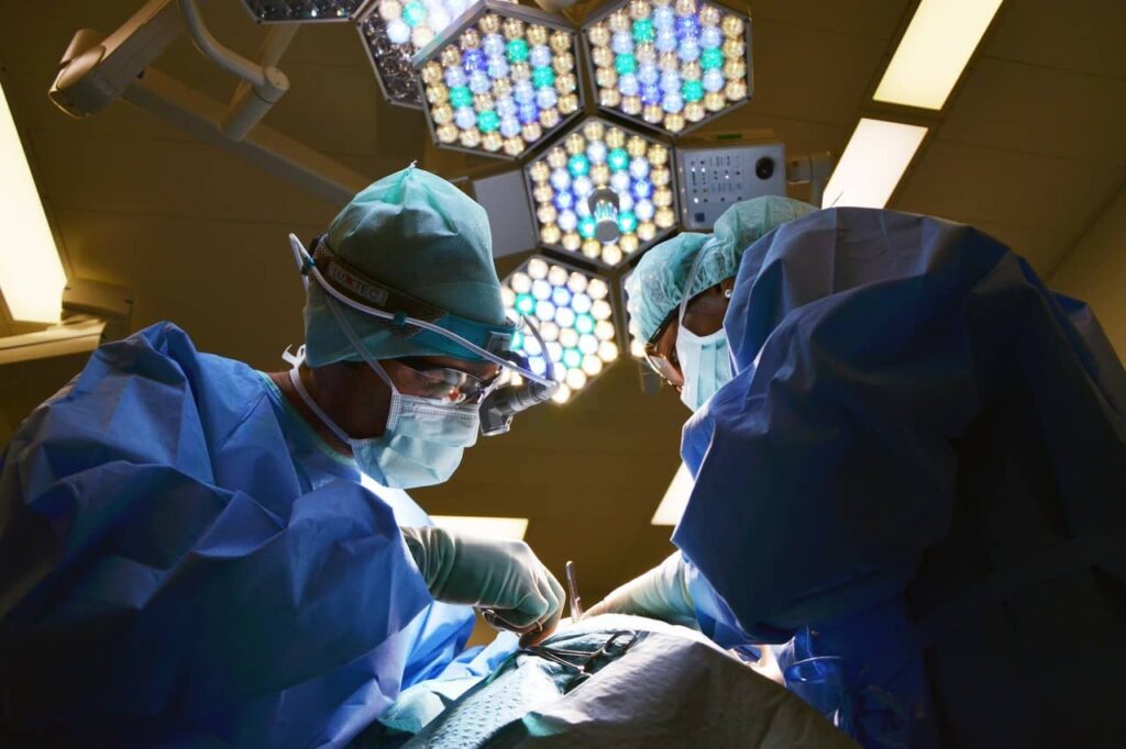 Emergency room nurses treating patient's wounds.