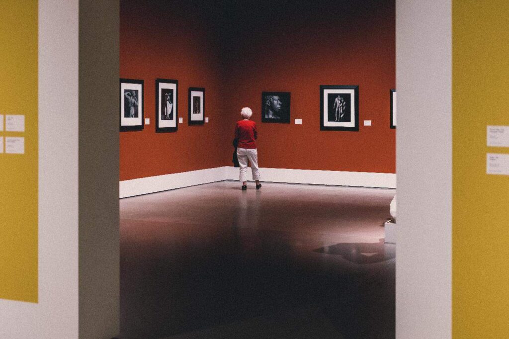 Exhibit designer reviewing the art display in the museum.