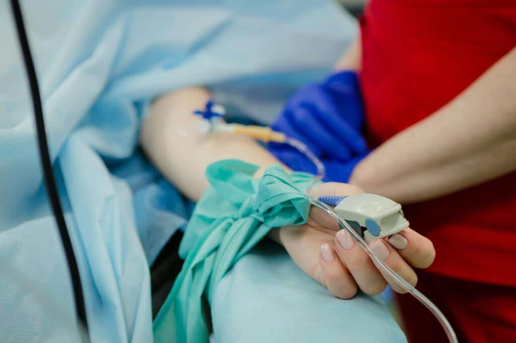 Perianesthesia nurse checking her patient's respiration rate.