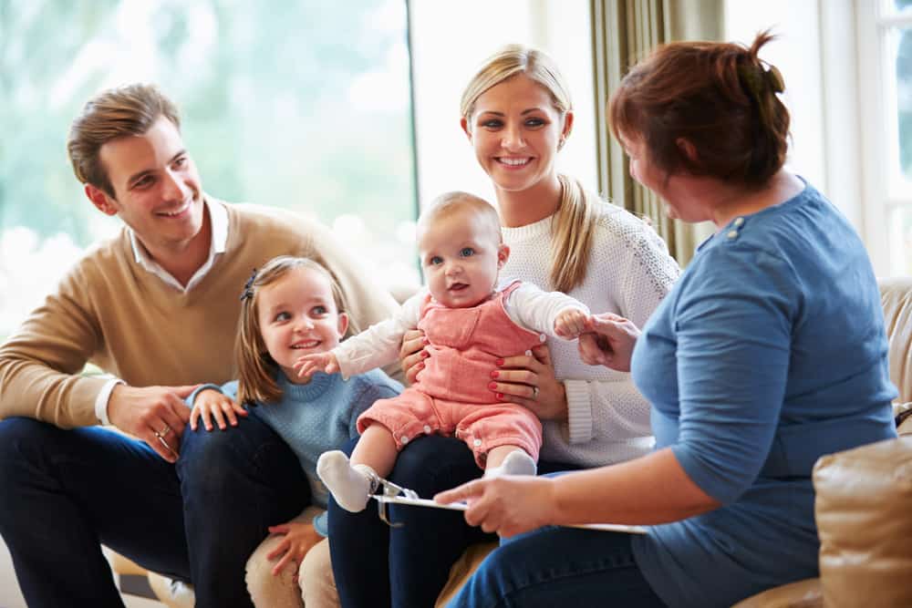 Family advocate talking to family with a baby.