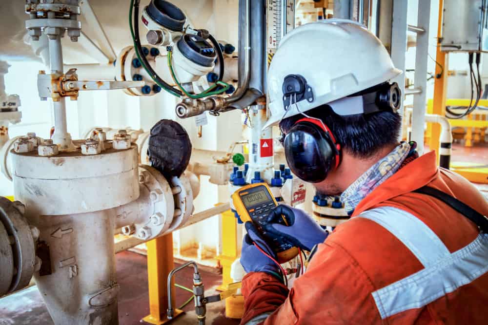 Mechanical engineer calibrating an instrument device.