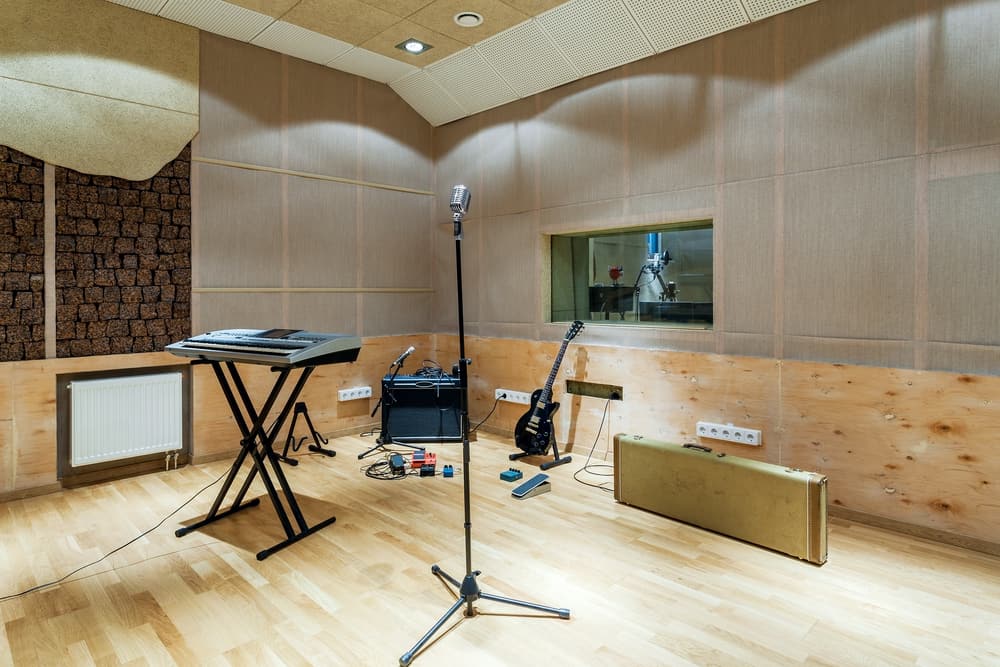 Sound recording studio with soundproofing and music instruments.