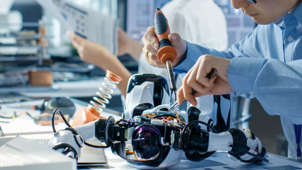 Mechanical engineer working on a robot prototype.