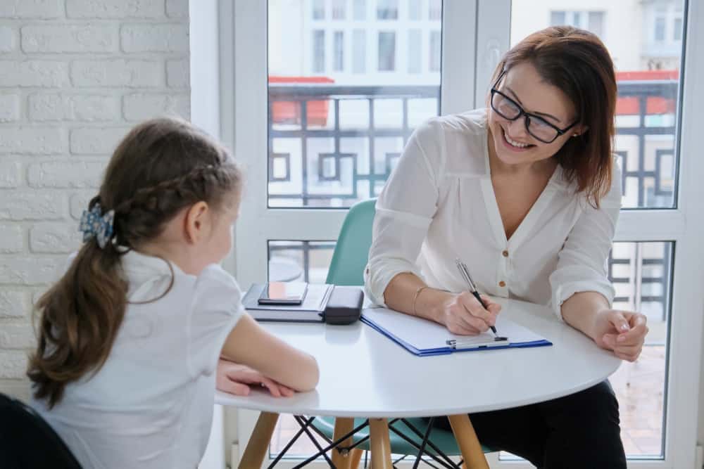 School social worker talking to the little girl.