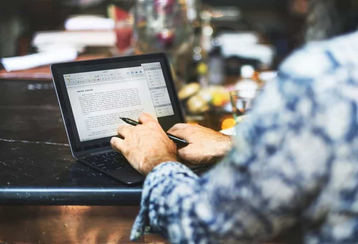 Man typing on a laptop.