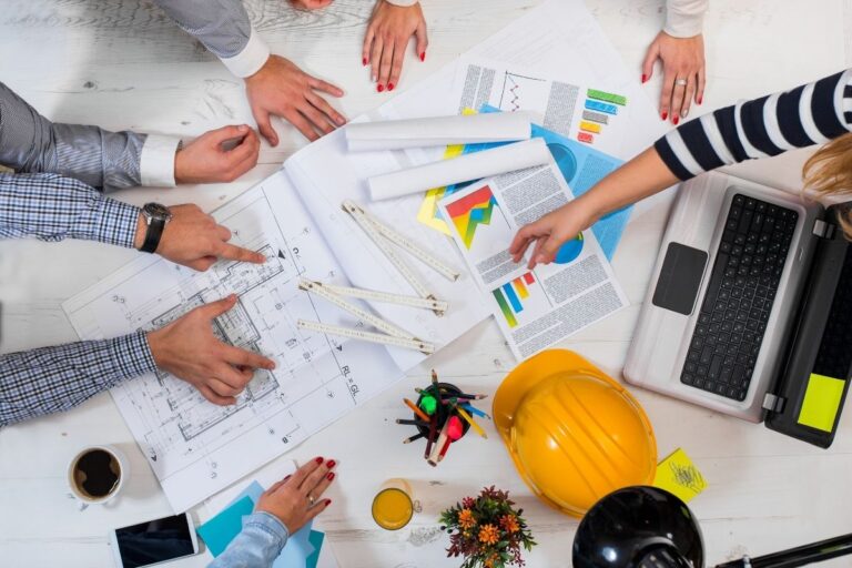 Group of people analaysing an architectural project.