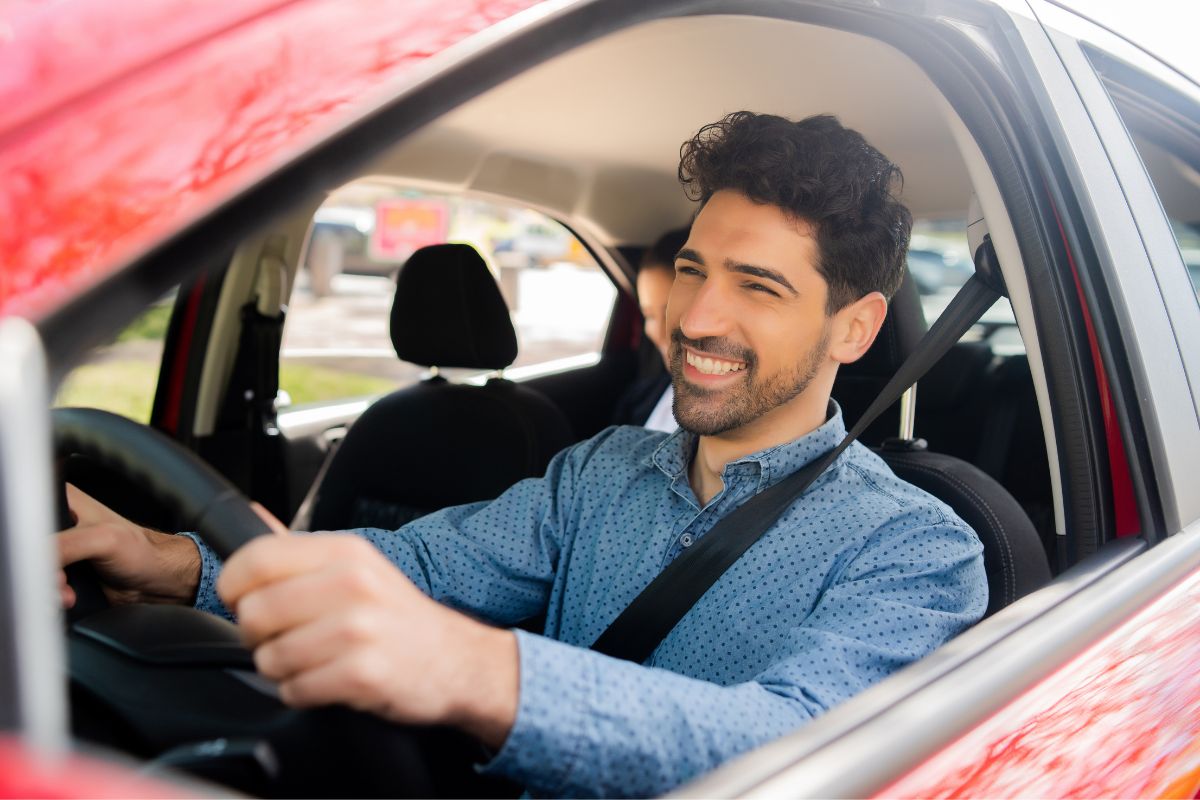 Male driver with a business woman passenger at the back seat.