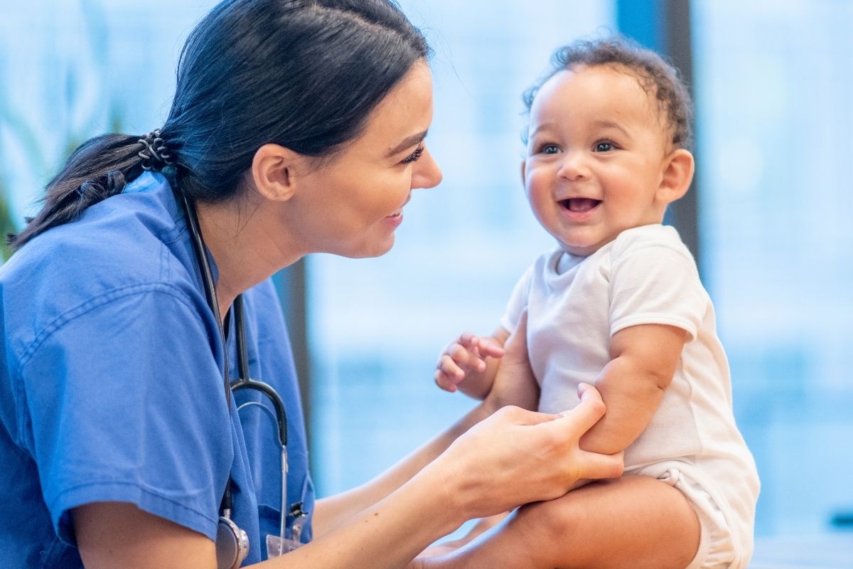 Nurse practitioner cheking out a young baby.