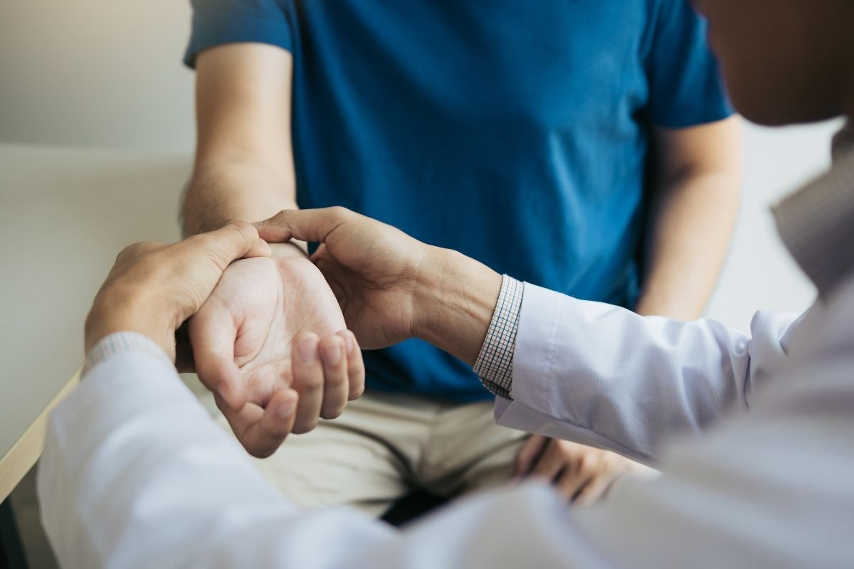 Physical therapist checking patient's wrist.