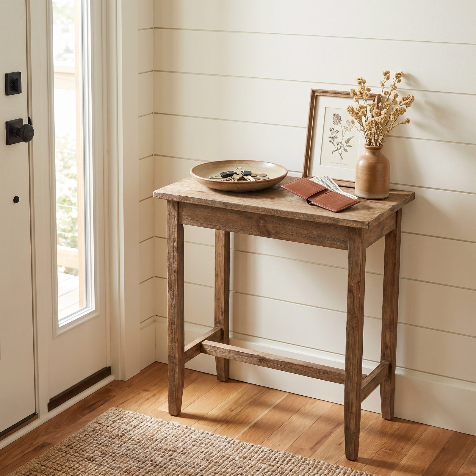 Entry console table with a key dish, coins, and an open leather wallet showing the edges of bills.